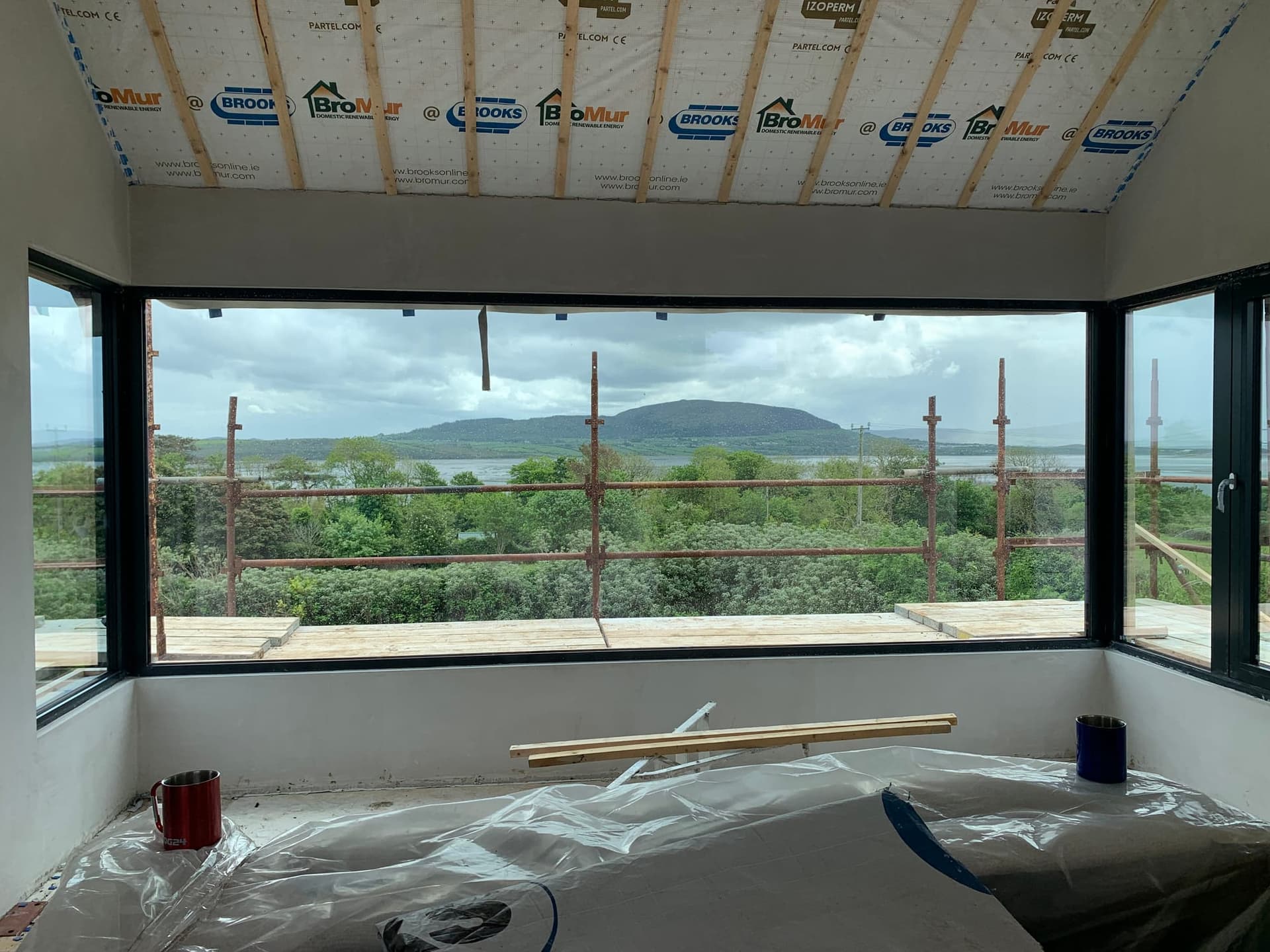 Triple-glazed black corner window framing a countryside view, installed by MDM Windows & Doors