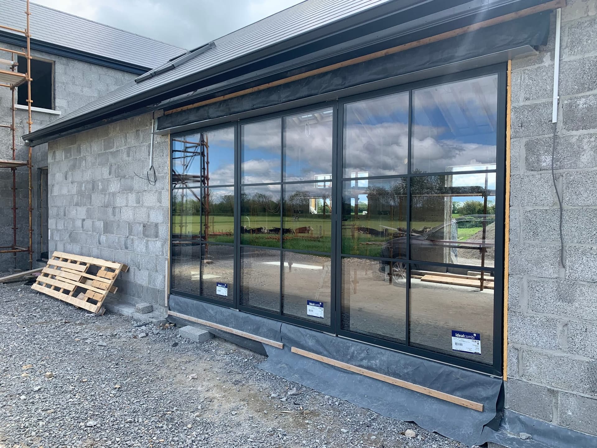 Slim black Crittall-style steel-look window wall on a new build, installed by MDM Windows & Doors
