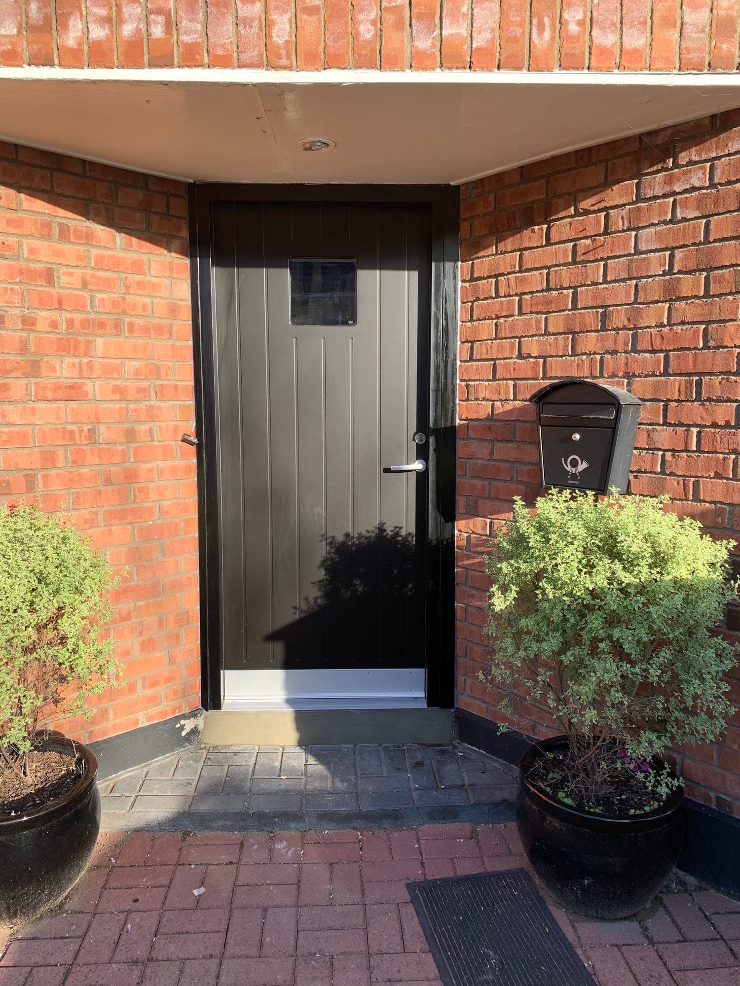 Anthracite front door with a glazed vision panel fitted to a red-brick Dublin home by MDM Windows & Doors